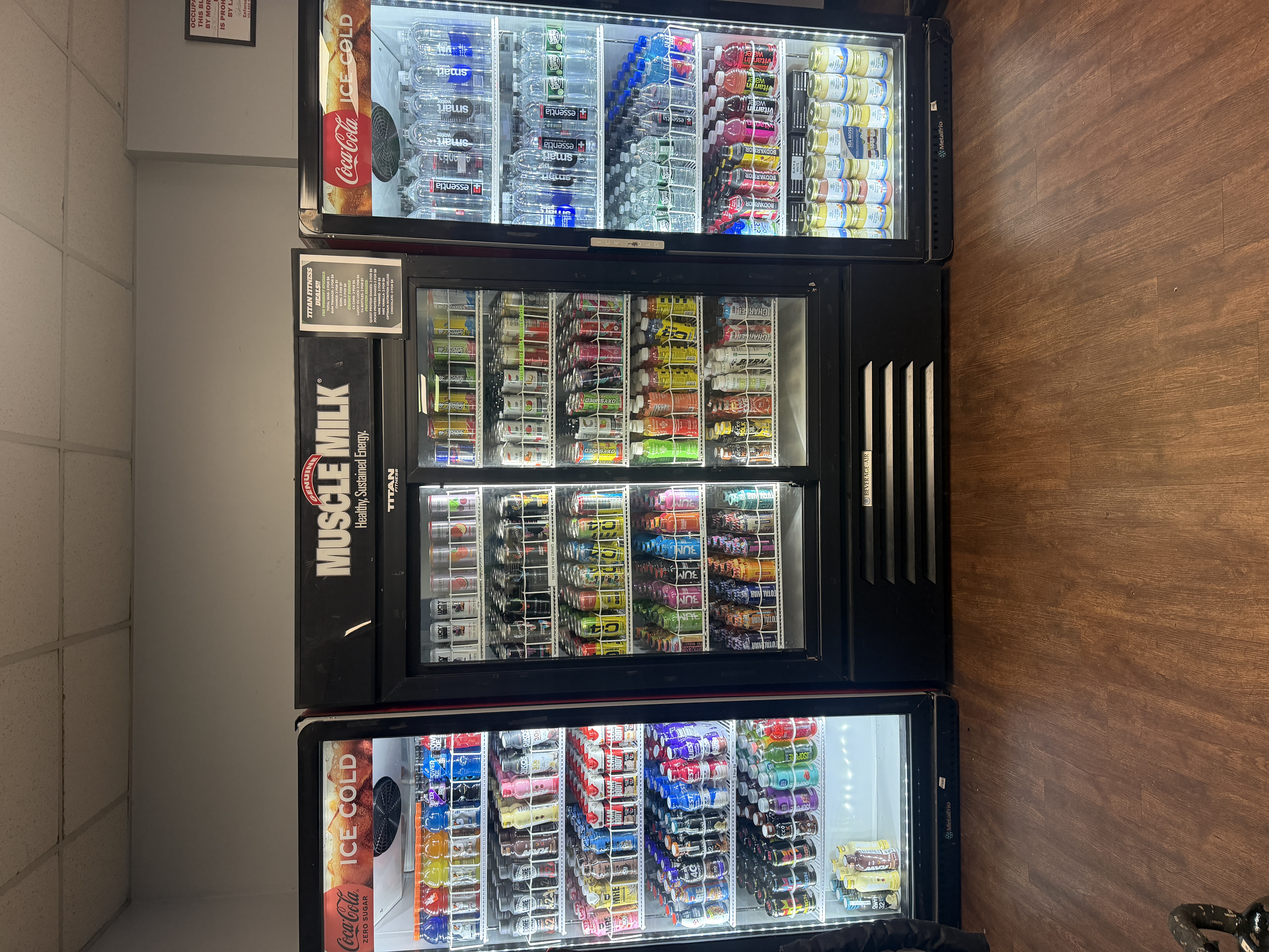 Three fully stocked drink fridges at Titan Fitness