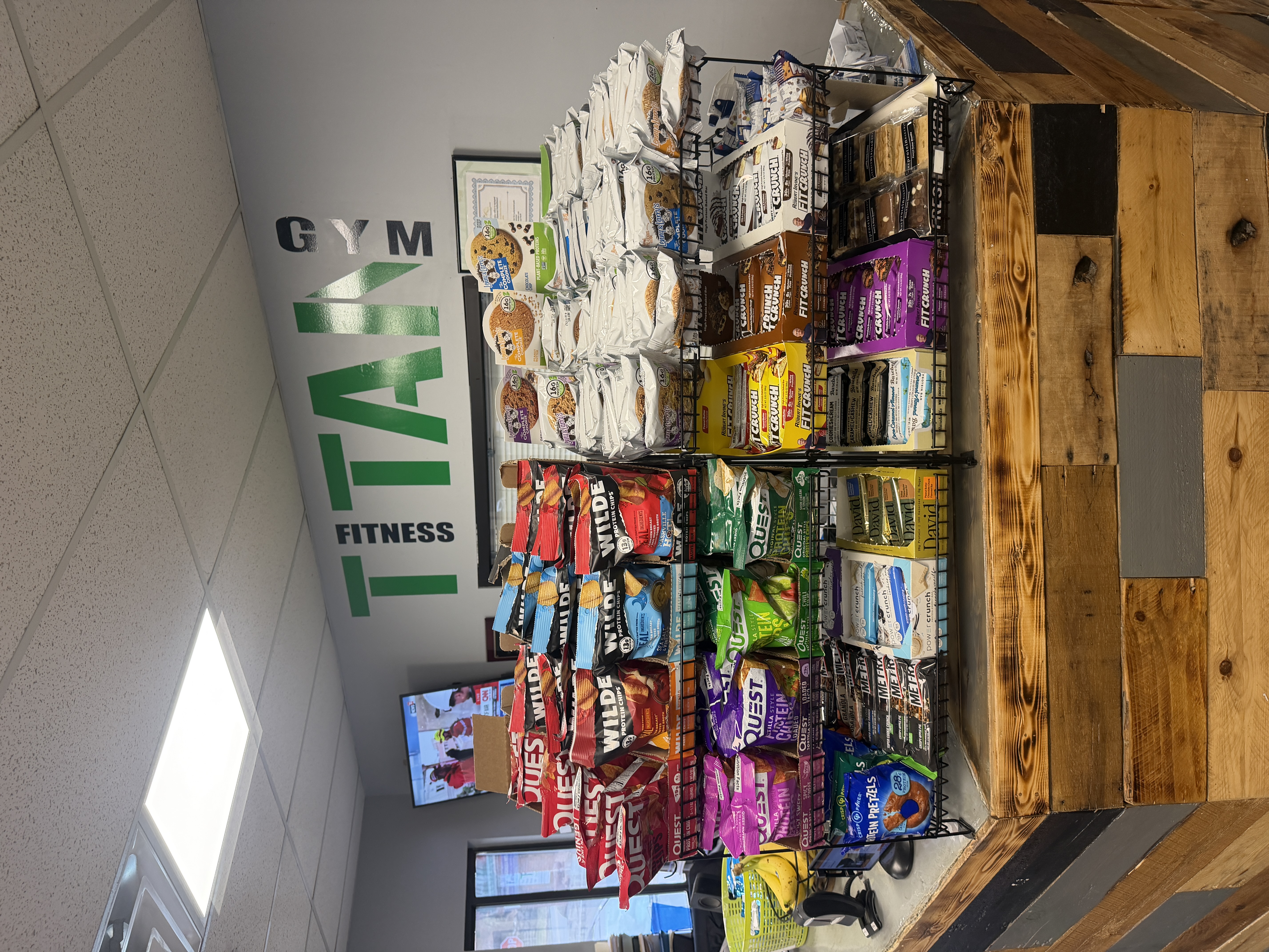 Titan Fitness snack bar with Quest, FitCrunch, and Wilde protein snacks